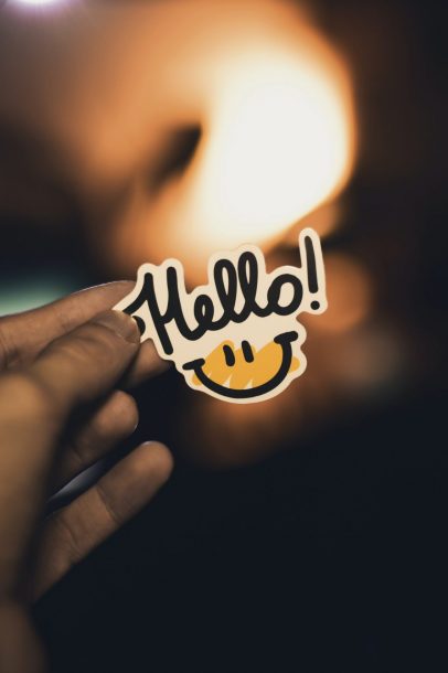 person holding Hello! sticker