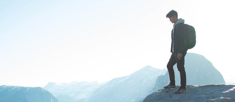 man standing on cliff