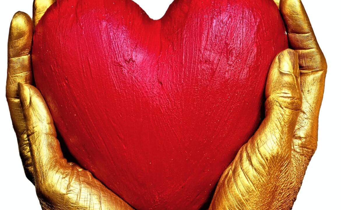 Photo by Marek Studzinski person holding red heart shaped ornament