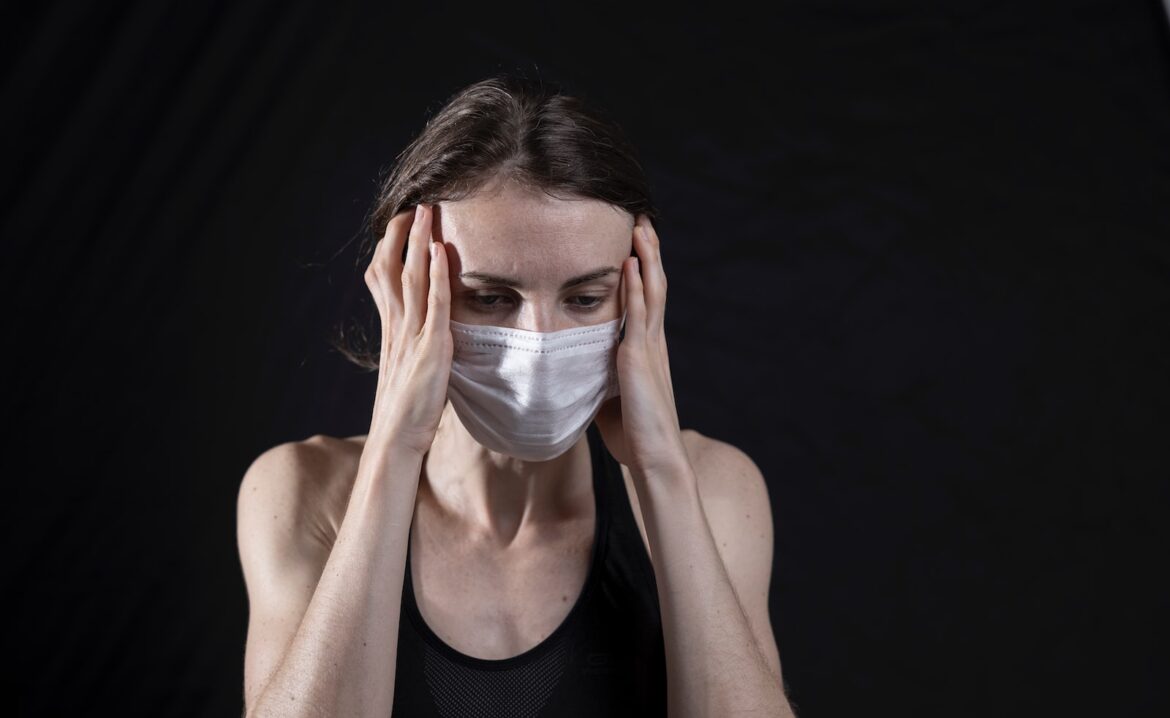 Photo by engin akyurt woman in black tank top covering her face with her hands