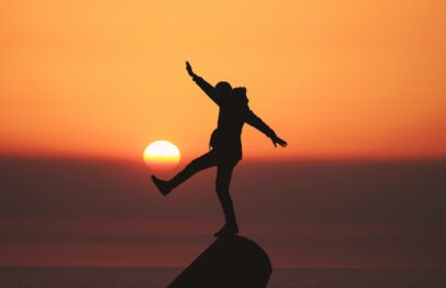 Photo by Aziz Acharki photo of silhouette photo of man standing on rock